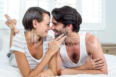 Happy couple lying on bed