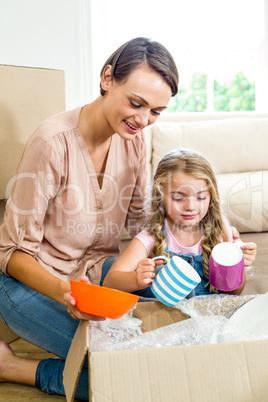 Mother and daughter removing containers from box