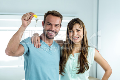 Happy couple with key at new house