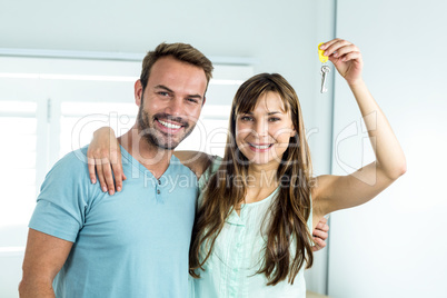 Couple smiling while showing house key
