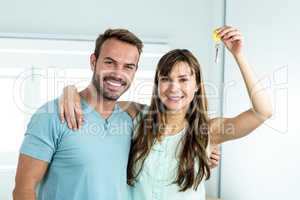 Couple smiling while showing house key