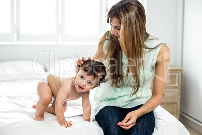 Mother with smiling son on bed