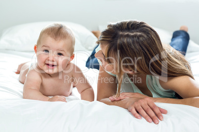 Mother and cute son lying on bed