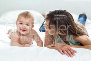 Mother and cute son lying on bed