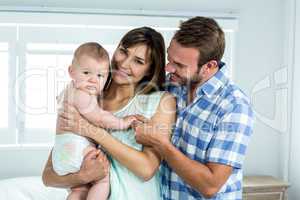 Parents with cute son in bedroom