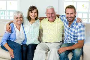 Happy family sitting on sofa at home