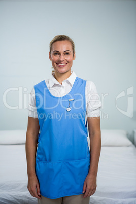 Portrait of smiling caregiver standing at home