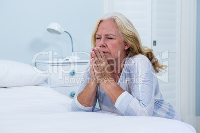 Woman praying in bedroom