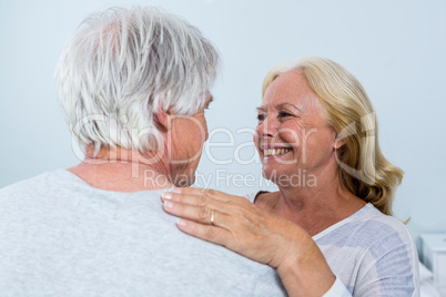 Happy woman looking at man while embracing