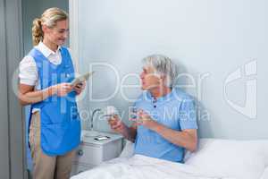 Nurse holding digital tablet at hospital
