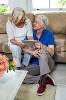 High angle view of happy senior couple using digital tablet