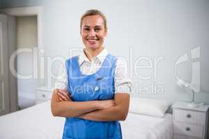 Female nurse with arms crossed standing at hospital