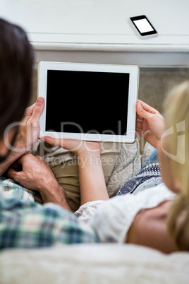Cropped image of couple with digital tablet at home Cropped image of couple with digital tablet at home