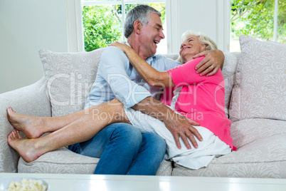 Romantic senior couple sitting on sofa