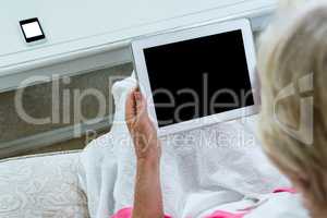 High angle view of senior woman holding digital tablet