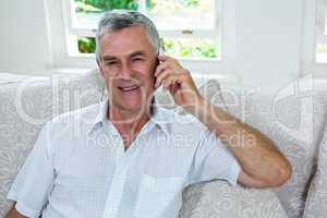 Portrait of happy senior man talking on mobile phone