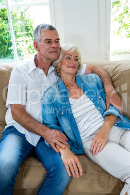 Senior woman relaxing on husband in sitting room
