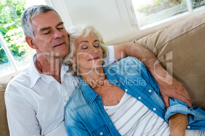 Senior couple relaxing on sofa in sitting room
