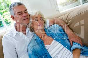 Senior couple relaxing on sofa in sitting room