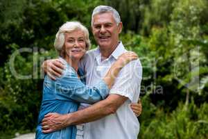 Portrait of loving senior couple in back yard