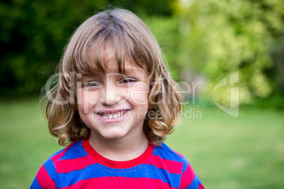 Portrait of cute boy in back yard