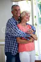 Romantic couple embracing in kitchen at home