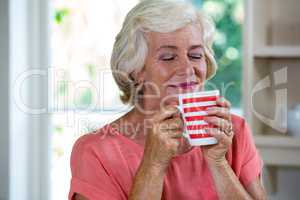 Senior woman having coffee at home