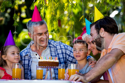 Family celebrating birthday at yard