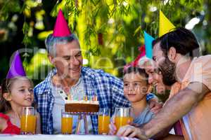 Family celebrating birthday at yard