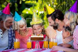 Smiling multi- generation family celebrating birthday