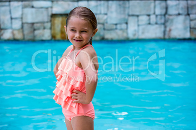 Girl standing at poolside