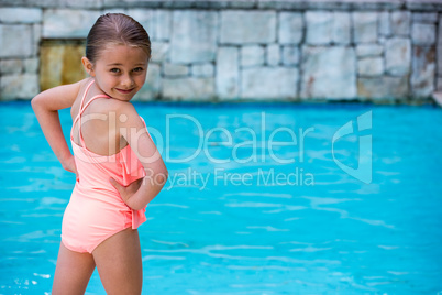 Portrait of girl standing at poolside