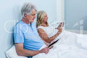 Retired couple with tablets
