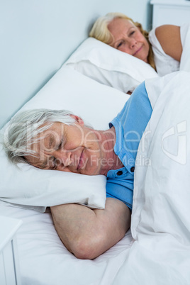 Senior couple resting on bed