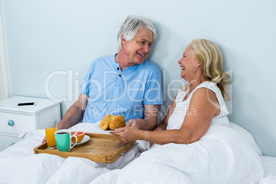 Happy senior couple with breakfast