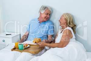 Happy senior couple with breakfast