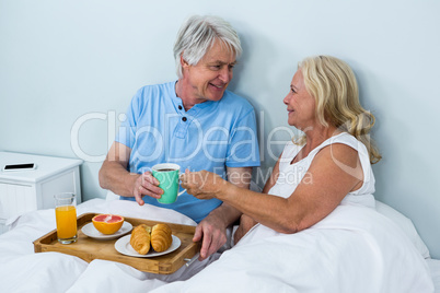 Cheerful senior couple with breakfast