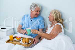 Cheerful senior couple with breakfast