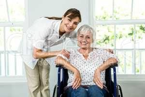 Portrait of smiling senior woman with nurse