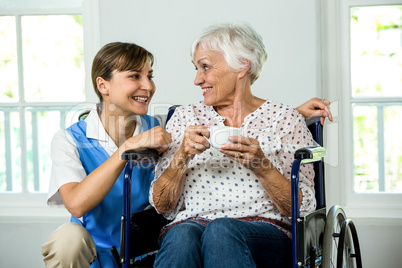 Smiling senior woman with nurse