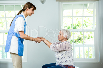 Nurse assisting senior woman
