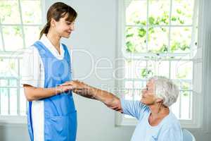 Smiling nurse assisting active senior