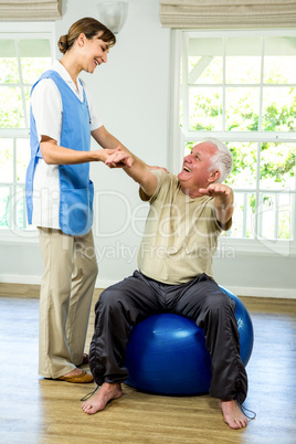 Happy senior man being examined by nurse