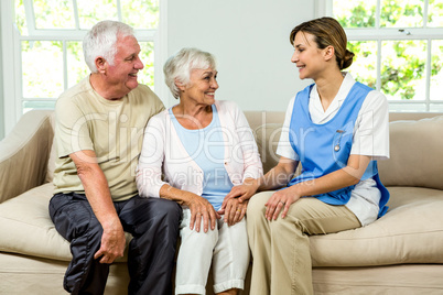 Smiling senior man and woman with nurse