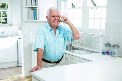 Happy senior man talking on phone