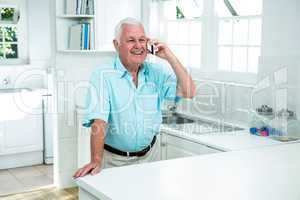 Happy senior man talking on phone