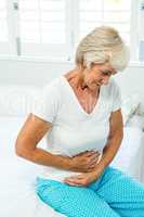 Senior woman suffering from stomach ache