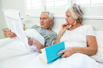 Senior couple reading newspaper