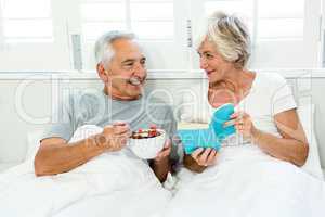 Senior couple relaxing on bed