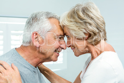 Side view of happy senior couple standing face to face